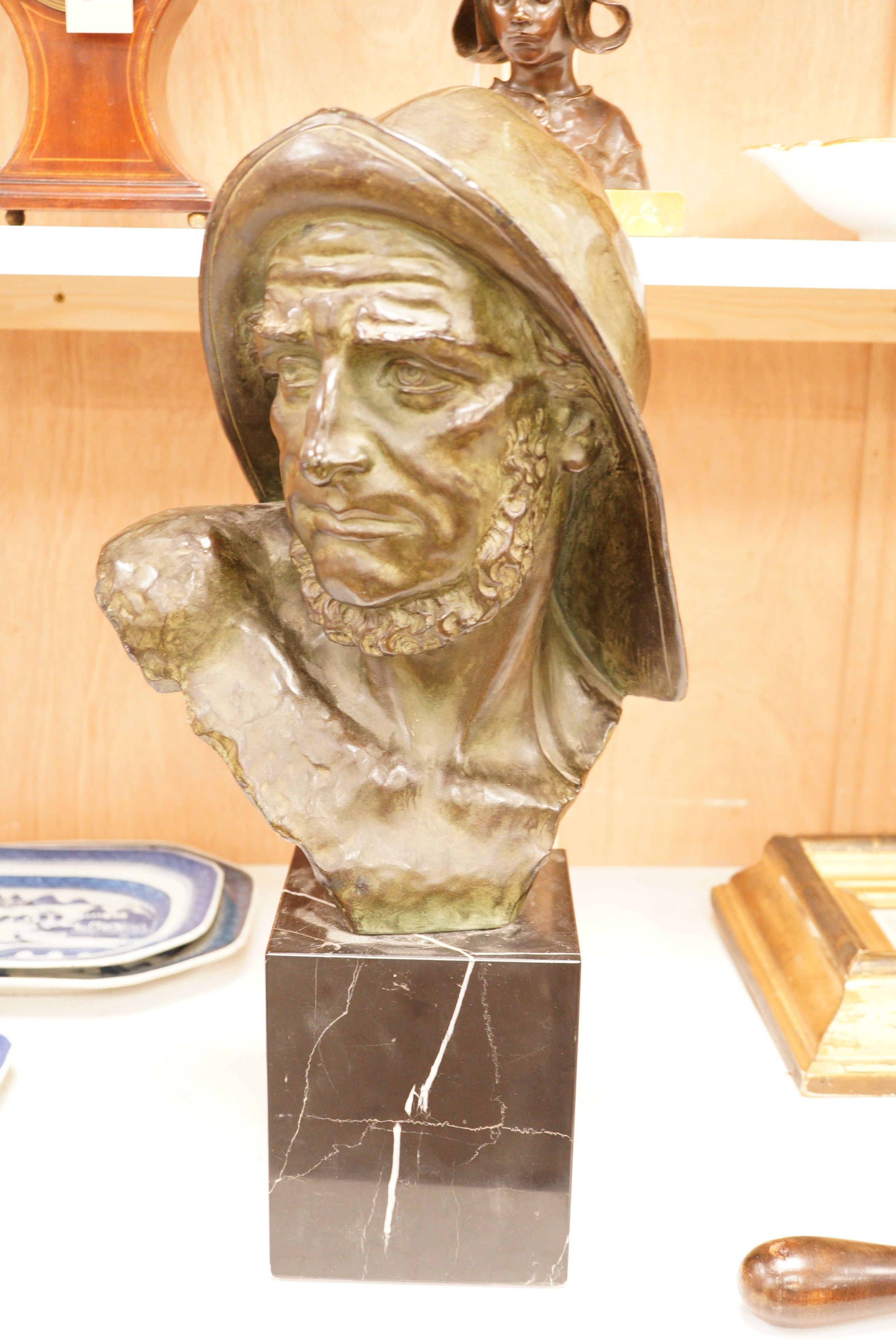 Johannes Dommisse (1878-1955) A cold painted terracotta bust of a fisherman on plinth base, 53cm tall